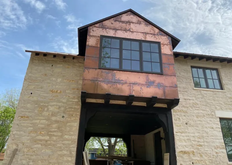 Copper metal panel facade on a stone building for Skylight Installation in Lockhart